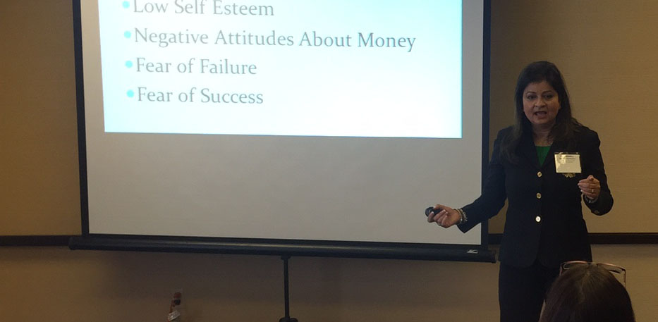 Hena speaking beside a presentation slide