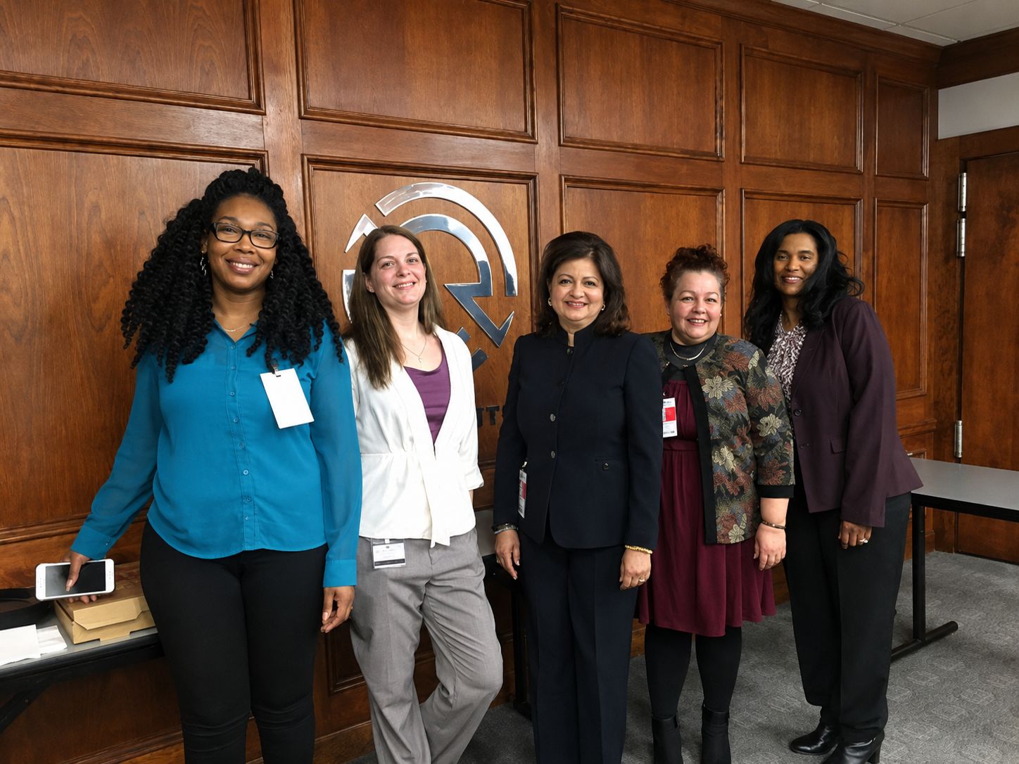 Hena standing with a group after a speaking event